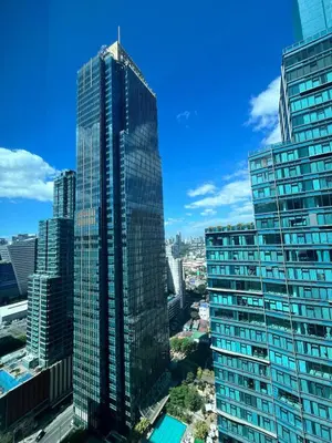 a view of a tall building in a city at Cozy 1br unit in Uptown BGC in Manila