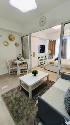 a living room with a couch and a table at SM Bicutan Escape Staycation in Manila