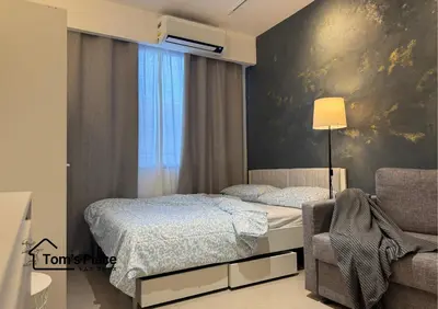 a bedroom with a bed and a chair at Tom's Place in Manila