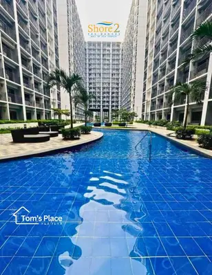a large blue pool in front of some tall buildings at Tom's Place in Manila