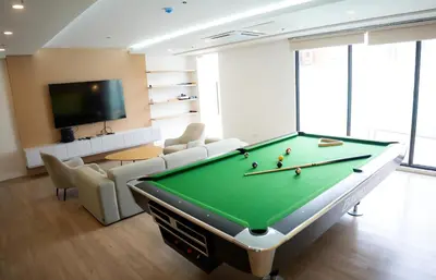 a living room with a pool table and a tv at I-LAND Residences Sucat near NAIA w Wifi free parking in Manila