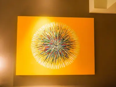 a yellow picture of a flower on a wall at The Hotel Residences at Acqua Tower in Manila