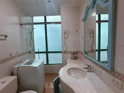 a bathroom with a sink and a toilet and a mirror at Ocean view malate manila in Manila