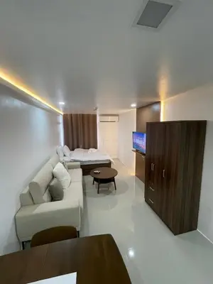 a living room with a couch and a bed at Makati City Antel Spa Residences 9B in Manila