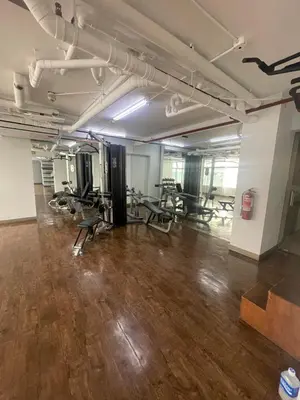 a gym with treadmills and chairs in a room at Makati City Antel Spa Residences 9B in Manila