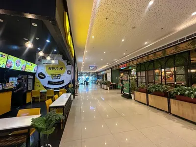 a shopping mall with a food truck on the wall at air residences in Manila