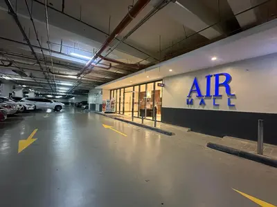 an empty parking garage with an air max sign on the wall at air residences in Manila
