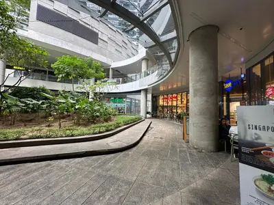 an empty shopping mall with trees and plants in it at air residences in Manila