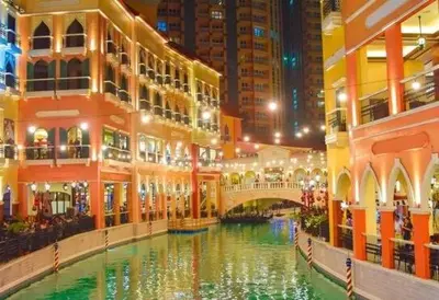 a shopping mall with a river in the middle at Studio unit near BGC and Makati in Manila
