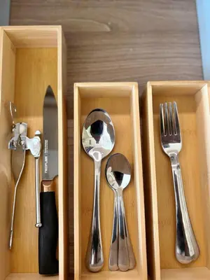 four utensils in a wooden box with forks and spoons at The Hotel Residences at Acqua in Manila
