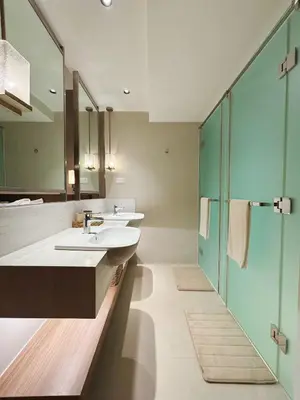 a bathroom with two sinks and a shower at The Hotel Residences at Acqua in Manila