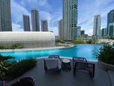 a swimming pool in a city with tall buildings at Hotel Residences At Acqua in Manila
