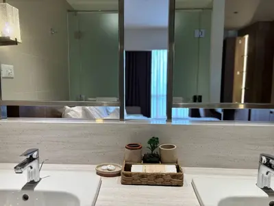 a bathroom counter with a sink and a mirror at The Hotel Residences at Acqua in Manila