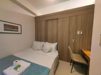 a hotel room with a bed and a desk at 1BR Condotel with Balcony at FAME Residences #FM37-1 in Manila