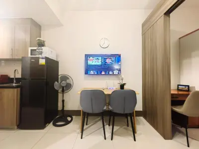 a kitchen with a table with two chairs and a refrigerator at 1BR Condotel with Balcony at FAME Residences #FM37-1 in Manila