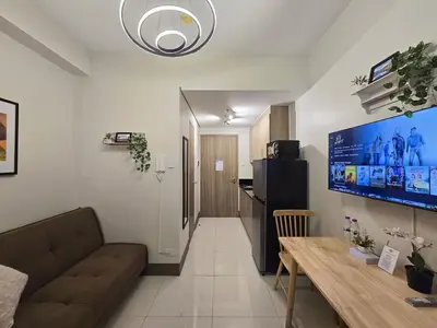 a living room with a couch and a table at 1BR Condotel with Balcony at FAME Residences #FM39-1 in Manila