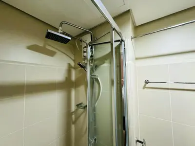 a shower with a glass door in a bathroom at 1BR Condotel with Balcony at FAME Residences #FM42-1 in Manila
