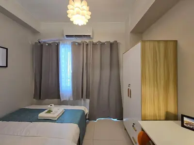 a hotel room with two beds and a window at 1BR Condotel with Balcony at FAME Residences #FM45-1 in Manila
