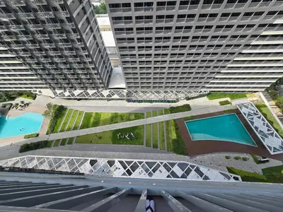 an aerial view of two tall buildings with two pools at 1BR Condotel with Balcony at FAME Residences #FM45-1 in Manila