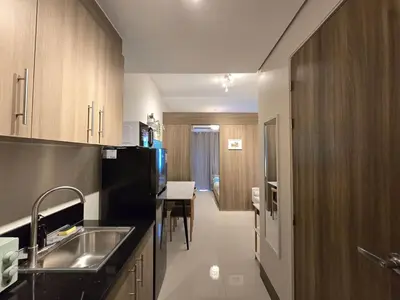 a kitchen with a sink and a table in it at 1BR Condotel with Balcony at FAME Residences #FM46-1 in Manila
