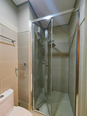 a glass shower in a bathroom with a toilet at 1BR Condotel with Balcony at FAME Residences #FM47-1 in Manila
