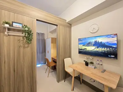 a dining room with a table and a clock on the wall at 1BR Condotel with Balcony at FAME Residences #FM48-1 in Manila
