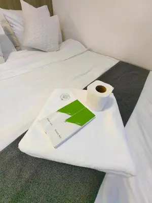 a book and a cup of coffee on a bed at 1BR Condotel with Balcony at FAME Residences #FM53-1 in Manila