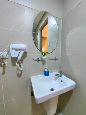a bathroom with a sink and a mirror at 1BR Condotel with Balcony at FAME Residences #FM53-1 in Manila