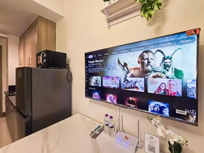 a large flat screen tv hanging on a wall at 1BR Condotel with Balcony at FAME Residences #FM54-1 in Manila