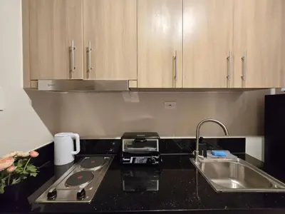 a kitchen with a sink and a counter top at 1BR Condotel with Balcony at FAME Residences #FM56-1 in Manila