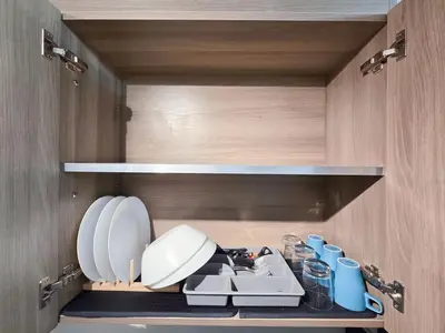 a kitchen with a sink and plates and cups at 1BR Condotel with Balcony at FAME Residences #FM57-1 in Manila