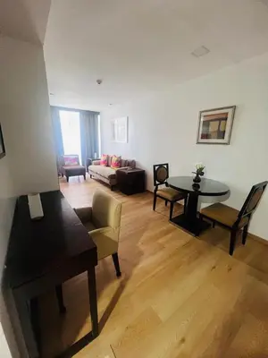 a living room with a couch and a table at Poblacion Makati Condo in Manila
