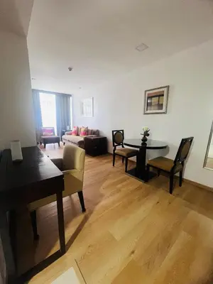 a living room with a couch and a table at Poblacion Makati Condo in Manila