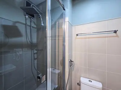 a bathroom with a shower and a toilet at 1BR Condotel with Balcony at FAME Residences #FM58-1 in Manila