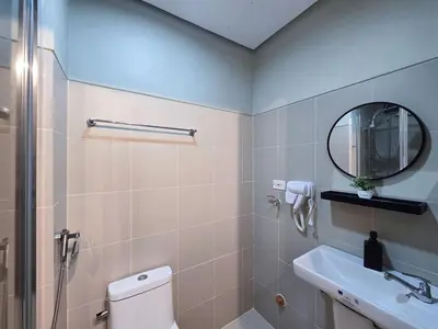 a bathroom with a toilet and a sink and a mirror at 1BR Condotel with Balcony at FAME Residences #FM58-1 in Manila