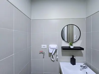 a white bathroom with a sink and a mirror at 1BR Condotel with Balcony at FAME Residences #FM61-1 in Manila