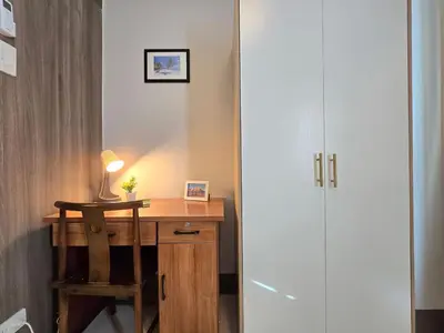a desk with a lamp and a chair next to a closet at 1BR Condotel with Balcony at FAME Residences #FM63-1 in Manila