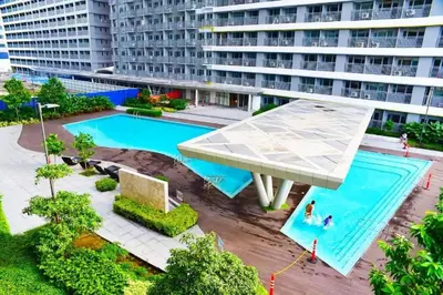 an overhead view of a swimming pool in a building at 1BR Condotel with Balcony at FAME Residences #FM63-1 in Manila