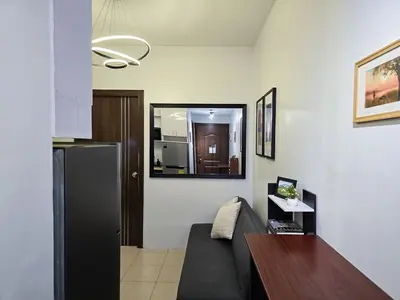 a living room with a couch and a refrigerator at 1BR Condotel Ridgewood Towers Near Airport #RW02-1 in Manila