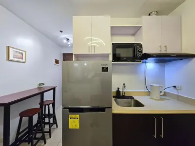 a kitchen with a stainless steel refrigerator and a counter at 1BR Condotel Ridgewood Towers Near Airport #RW02-1 in Manila