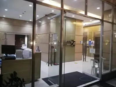 an office with a glass wall with a desk and a computer at 1BR Condotel Ridgewood Towers Near Airport #RW05-1 in Manila