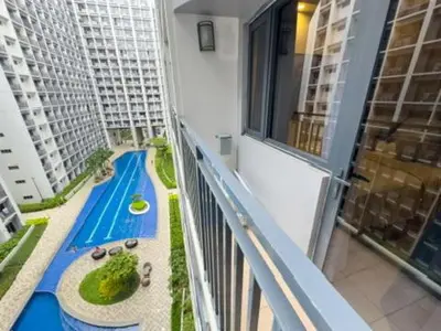 a balcony with a view of a swimming pool at MOA Staycation at Shore 2 Residences Tower 3 in Manila