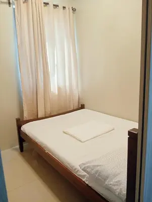 a bed in a room with a white curtain at Zenys Staycation at Shore 1 Residences in Manila