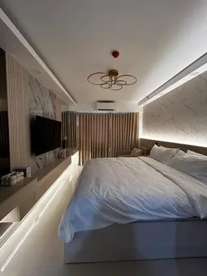 a bedroom with a large bed and a television at Hotel Like Staycation Near Airport and MOA Porongs Oasis in Manila