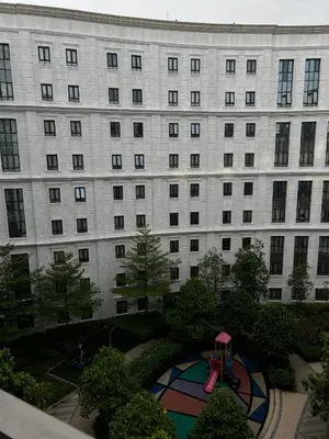 a large building with a playground in front of it at L&D Condominium in Manila