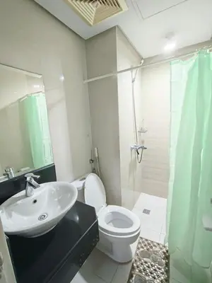a bathroom with a sink and a toilet and a shower at Rose150newportcondopasay in Manila