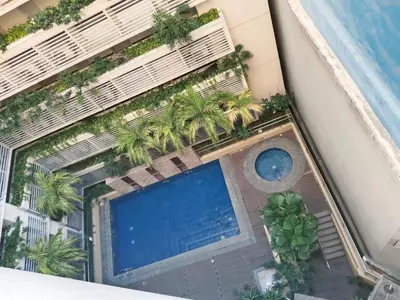 an overhead view of a building with a swimming pool at JennieRose150newportpasay in Manila