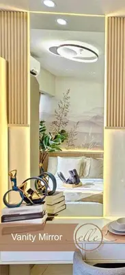 a room with a bed with a painting on the wall at Modern Unit at Shore 2 Mall of Asia by Elle Suite in Manila