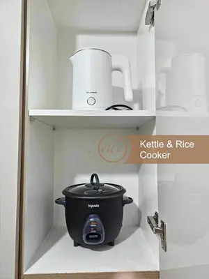 a pot and other appliances on shelves in a kitchen at Modern Unit at Shore 2 Mall of Asia by Elle Suite in Manila