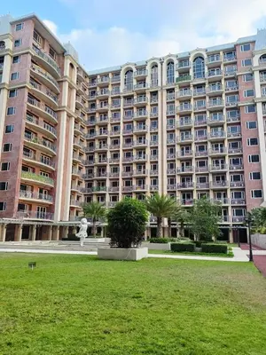 a large building with a statue in front of it at Condo near Moa with Pool Access WS1205 in Manila